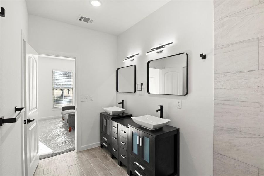 Bathroom with ensuite bath, wood finish floors, double vanity, and recessed lighting