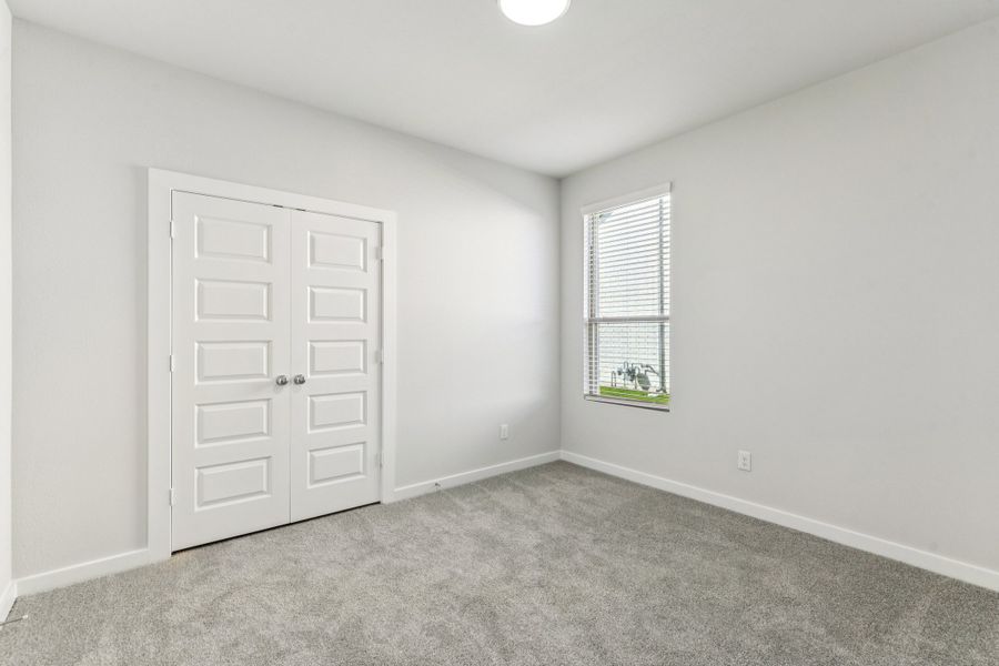 Bedroom in the Wimbledon home plan by Trophy Signature Homes – REPRESENTATIVE PHOTO Bedroom in the Wimbledon home plan by Trophy Signature Homes – REPRESENTATIVE PHOTO