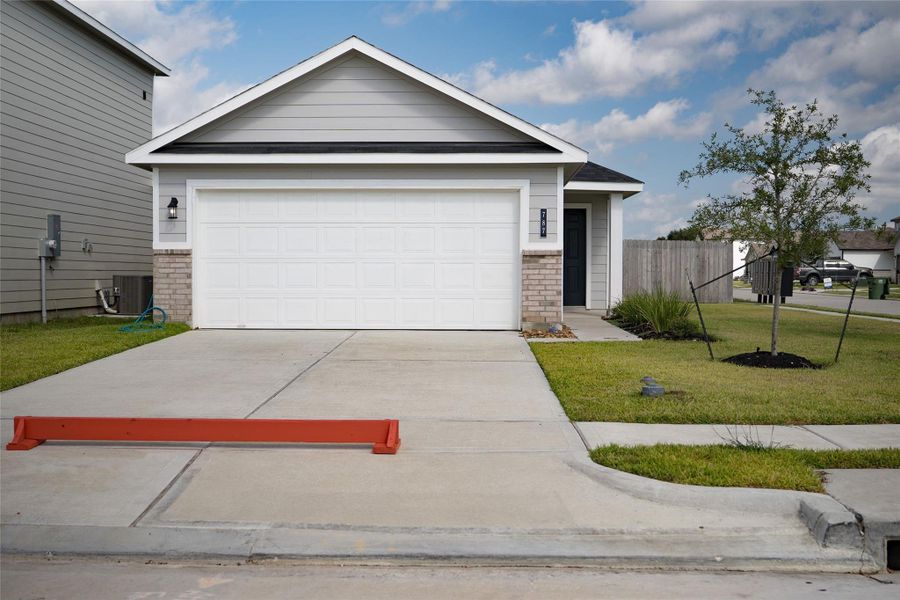 Front exterior of a new home in , Dayton, TX, highlighting curb appeal (Image 4).
