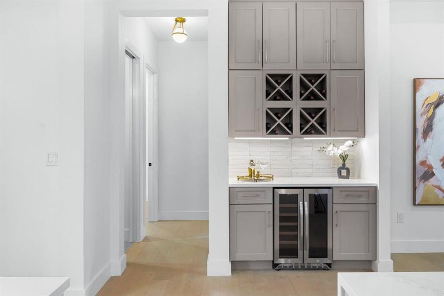 The dry bar in this chic kitchen is perfect for enjoying a leisurely drink while whipping up gourmet meals