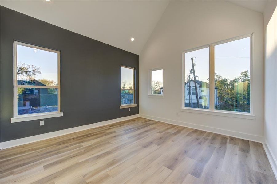 Primary bedroom features cathedral ceilings and lots of windows for natural light!