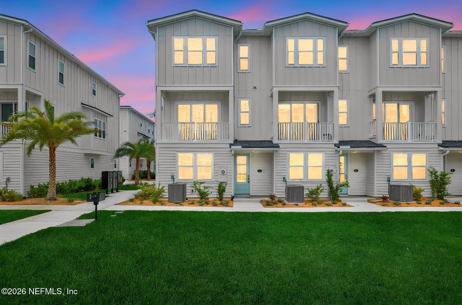 Front exterior of a new home in North Beach Townhomes, Jacksonville Beach, FL, highlighting curb appeal (Image 2). Front exterior of a new home in North Beach Townhomes, Jacksonville Beach, FL, highlighting curb appeal (Image 2).