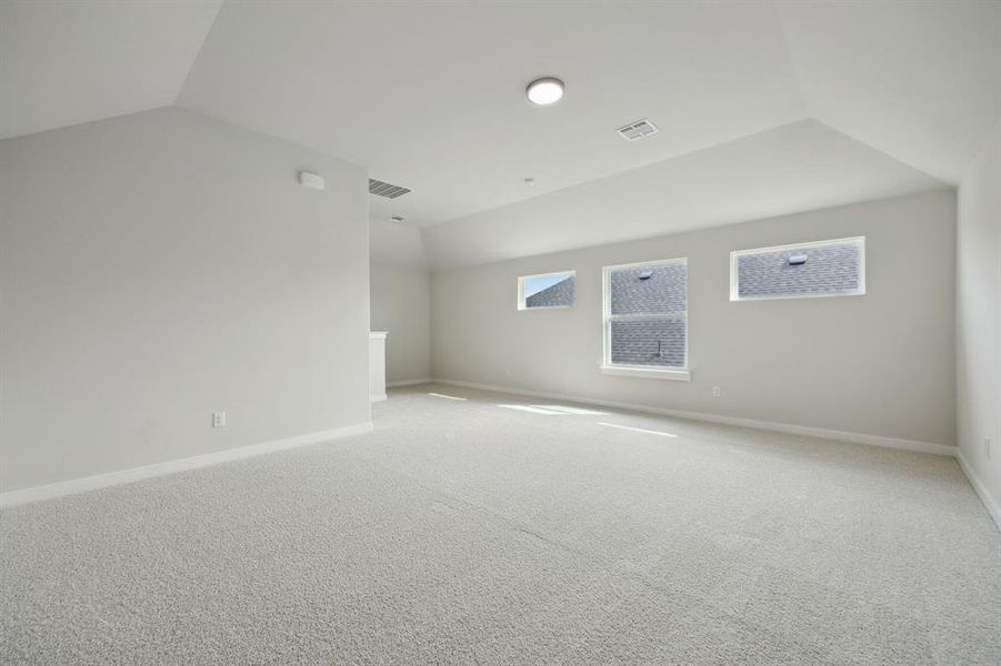 Upstairs gameroom with vaulted ceiling