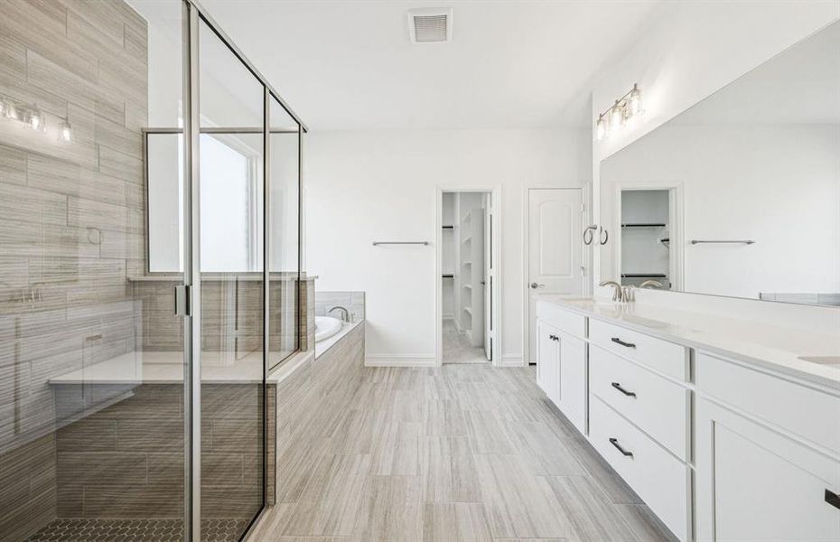 Luxurious owner's bath complete with double sinks and a generous shower Luxurious owner's bath complete with double sinks and a generous shower