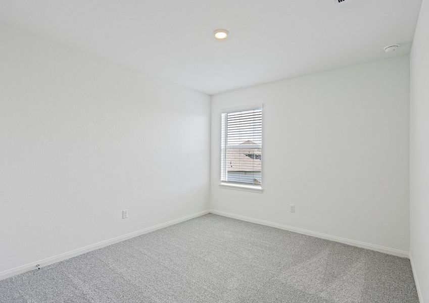 Secondary bedroom with lush carpet