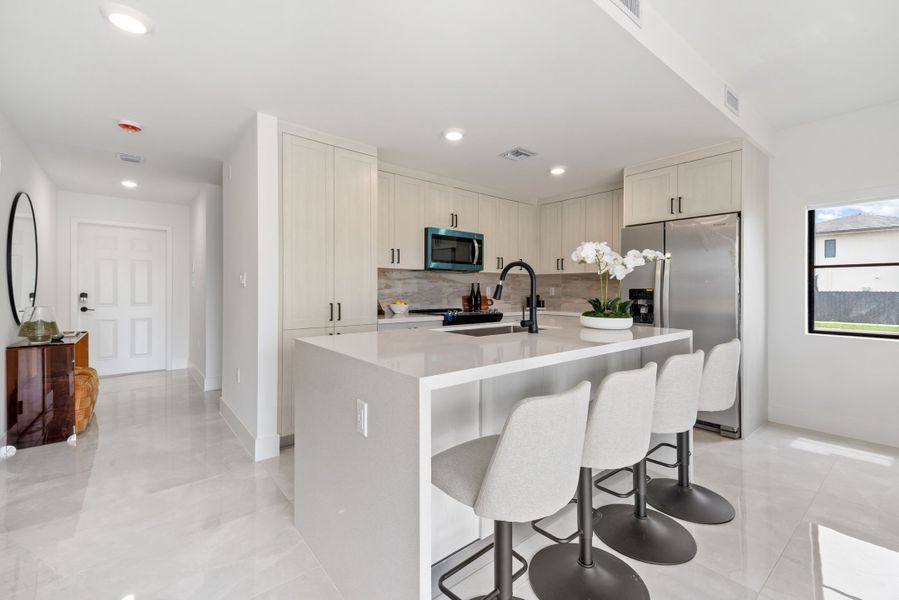 Representative furnished interior of a home built from the Model E by Onx Homes in On Alba, Florida City (Image 36).