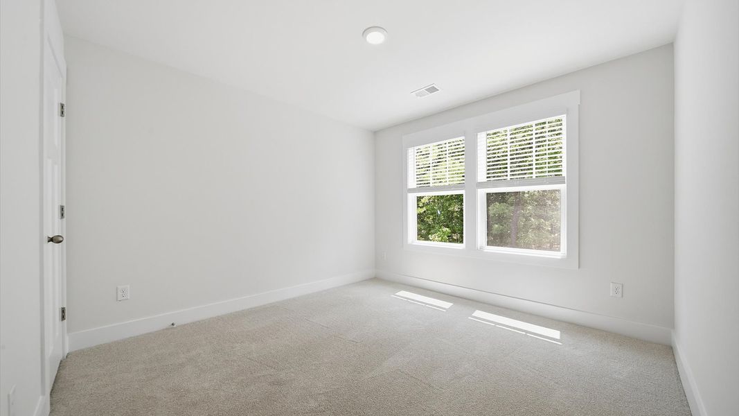 Accomplished design shines in this carpeted bedroom with a functional walk-in closet Accomplished design shines in this carpeted bedroom with a functional walk-in closet