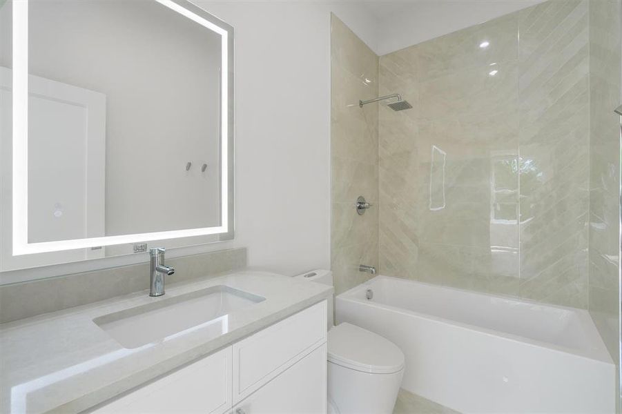 Full bath featuring vanity, toilet, and shower / washtub combination