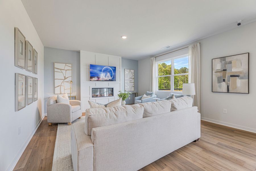 A living room with a couch and a table. A living room with a couch and a table.