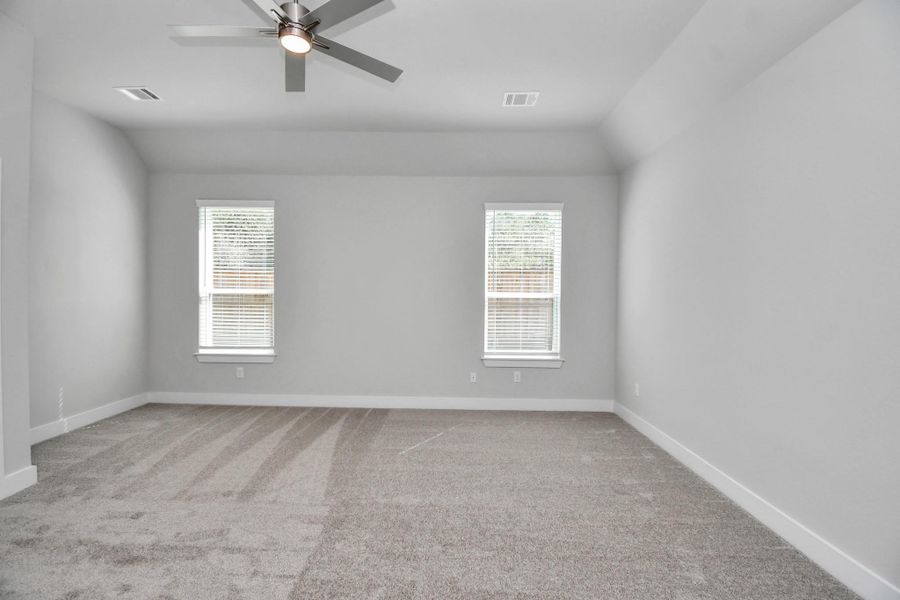 Escape and relax in the exquisite primary suite, a haven to unwind after a long day. The spacious room, boasts plush carpeting, soothing paint tones, high ceilings, and expansive windows adorned with privacy blinds. Sample photo of completed home with similar floor plan. Actual colors and selections may vary. Escape and relax in the exquisite primary suite, a haven to unwind after a long day. The spacious room, boasts plush carpeting, soothing paint tones, high ceilings, and expansive windows adorned with privacy blinds. Sample photo of completed home with similar floor plan. Actual colors and selections may vary.