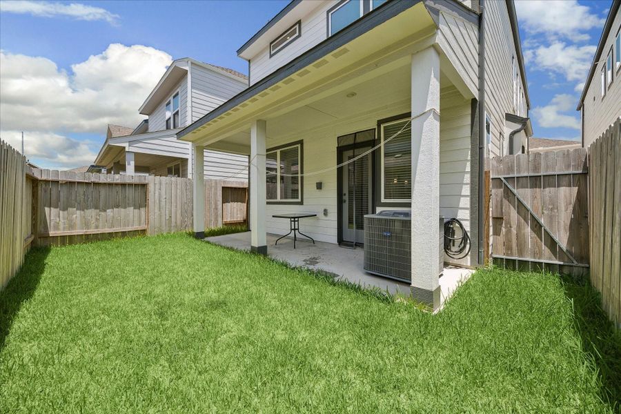 Exterior details and patio area of a home in Dunvale Village - Townhome Collection, Houston (Image 4).