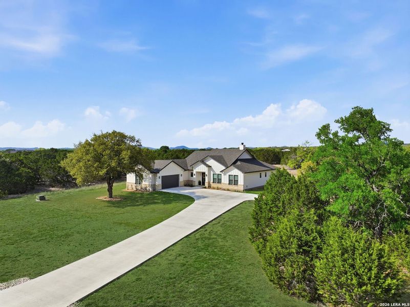 Front exterior of a new home in , Bandera, TX, highlighting curb appeal (Image 21).
