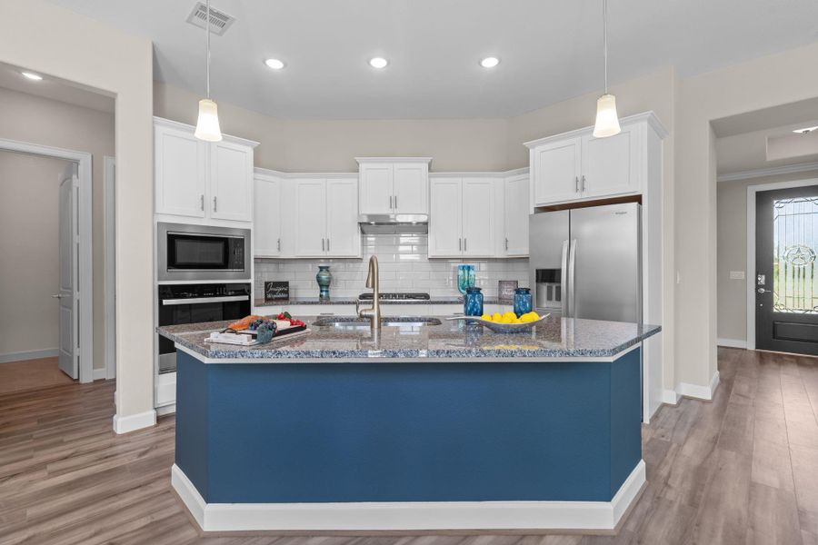 The Portico kitchen combines style and function with sleek finishes, ample counter space, and an open layout that keeps you connected while you cook. Image depicts home as-is.