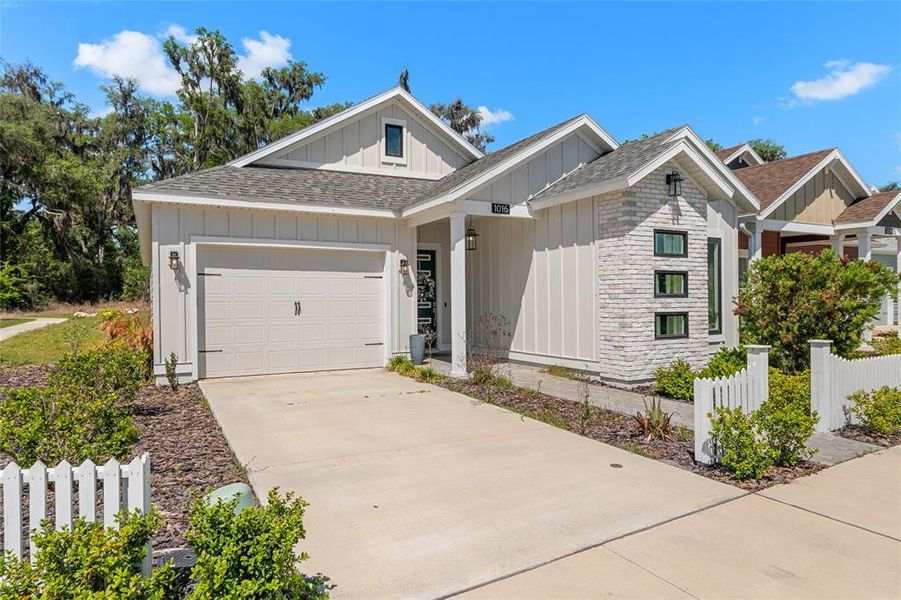 Front exterior of a new home in Fairway Pointe at West End, Newberry, FL, highlighting curb appeal (Image 25).
