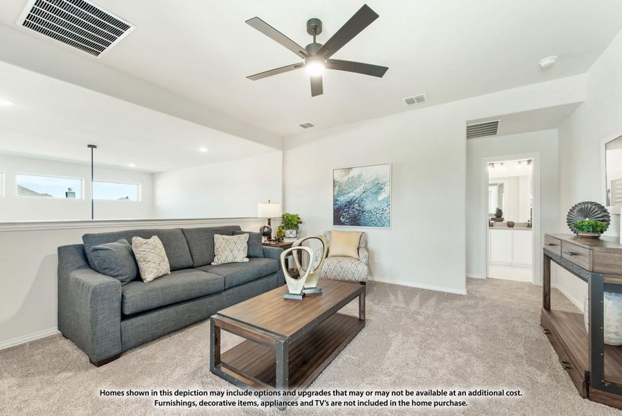 Living room with gray sofa, wood coffee table, ceiling fan, and carpet flooring
