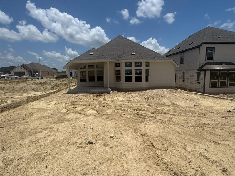 Rear view of house with a patio area Rear view of house with a patio area