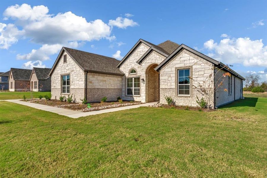 Front exterior of a new home in Fannin Ranch, Leonard, TX, highlighting curb appeal (Image 22). Front exterior of a new home in Fannin Ranch, Leonard, TX, highlighting curb appeal (Image 22).
