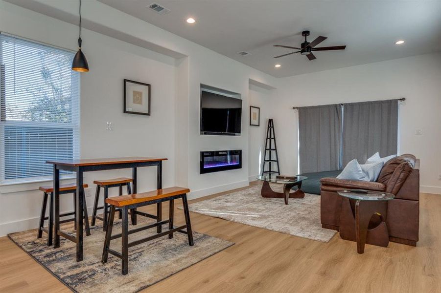 Living room featuring light hardwood / wood-style floors and ceiling fan