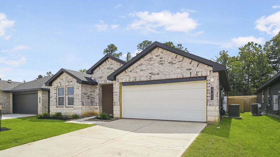 Front exterior of a new home in Grand Pines, Magnolia, TX, highlighting curb appeal (Image 2). Front exterior of a new home in Grand Pines, Magnolia, TX, highlighting curb appeal (Image 2).