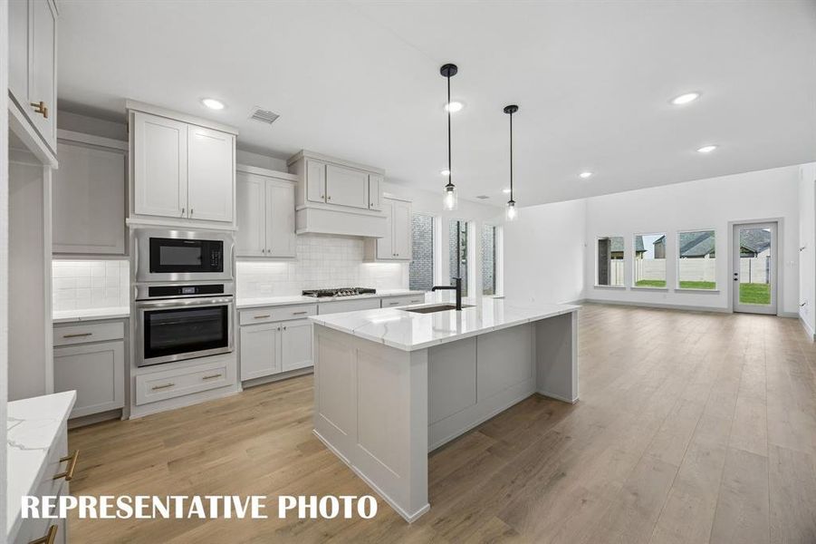The spacious kitchen island is this centerpiece of this chefs kitchen and the perfect place for friends and family to gather round.  REPRESENTATIVE PHOTO