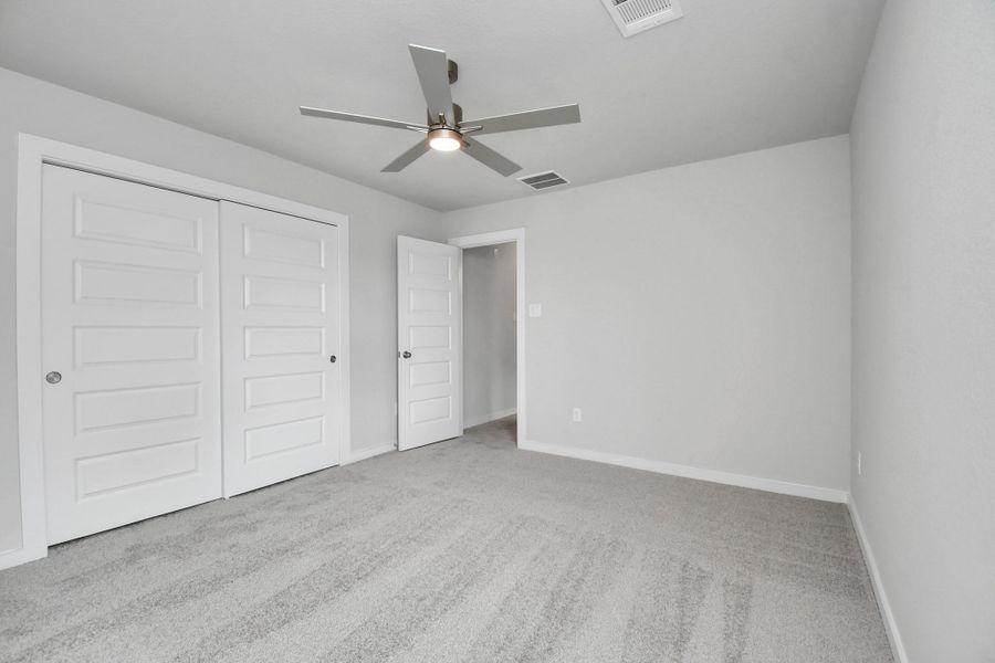 Secondary bedroom features plush carpeting, large windows that let in plenty of natural light, bright paint, and spacious closets. Secondary bedroom features plush carpeting, large windows that let in plenty of natural light, bright paint, and spacious closets.