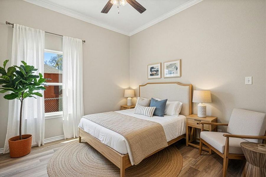 4403 N. Port Ridglea Ct. Granbury,TX 76049 Bedroom with wood finished floors, crown molding, and a ceiling fan "Virtually staged to help you visualize the potential of this space."