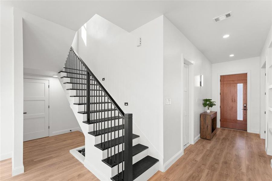 Entryway with light wood-type flooring and recessed lighting
