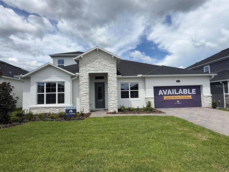Front exterior of a new home in Emerson Pointe, Apopka, FL, highlighting curb appeal (Image 2).