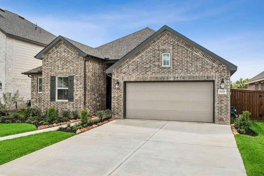 Front exterior of a new home in Harvest Pointe, Needville, TX, highlighting curb appeal (Image 2). Front exterior of a new home in Harvest Pointe, Needville, TX, highlighting curb appeal (Image 2).
