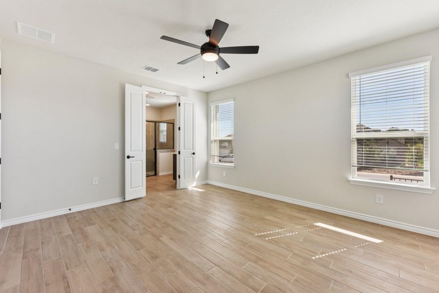 Unfurnished bedroom featuring ceiling fan and light wood-style floors