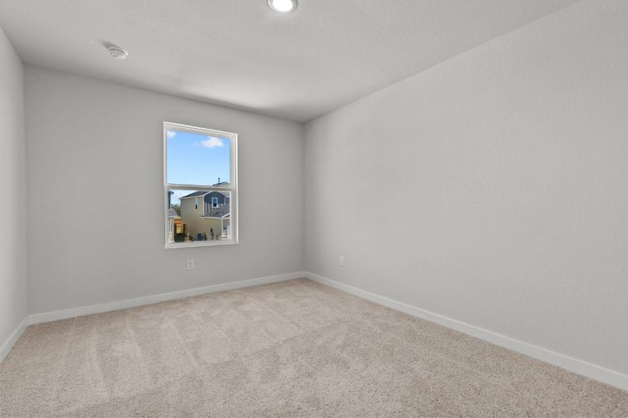 A room with a window and a carpet. A room with a window and a carpet.