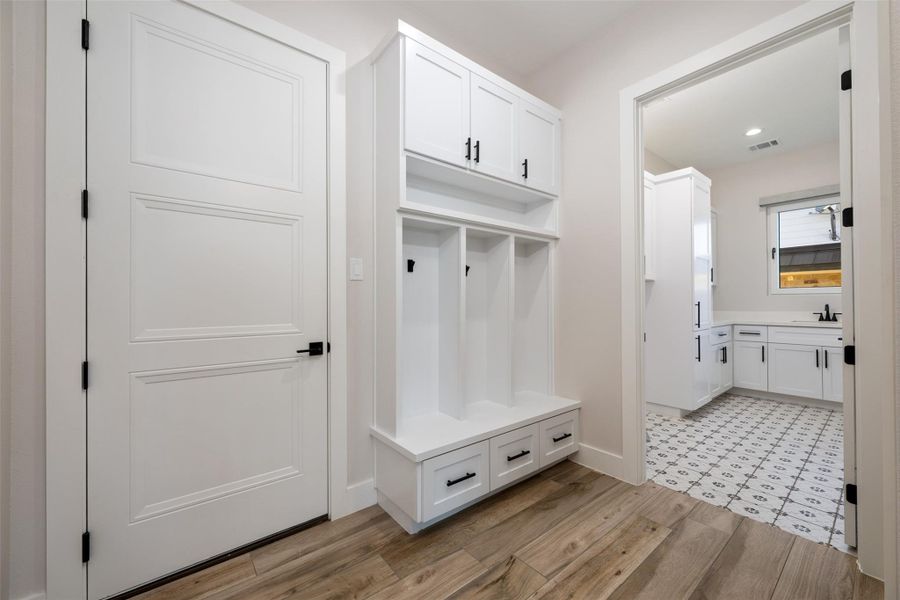 Mudroom featuring light hardwood / wood-style floors and sink