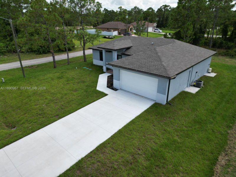 Front exterior of a new home in , Lehigh Acres, FL, highlighting curb appeal (Image 2). Front exterior of a new home in , Lehigh Acres, FL, highlighting curb appeal (Image 2).