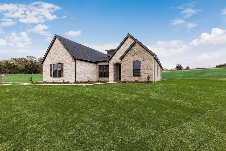 Front exterior of a new home in King Crossing Estates, Van Alstyne, TX, highlighting curb appeal (Image 1). Front exterior of a new home in King Crossing Estates, Van Alstyne, TX, highlighting curb appeal (Image 1).