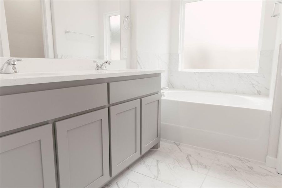 Bathroom with tile patterned flooring, a washtub, and dual vanity