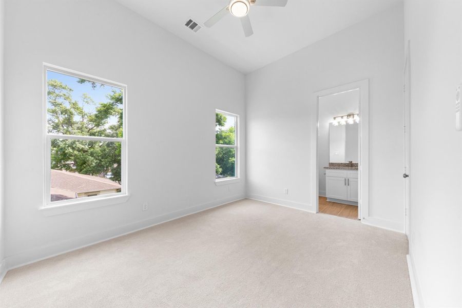 Secondary bedroom with neutral tones, ample closet space, and a comfortable layout. Secondary bedroom with neutral tones, ample closet space, and a comfortable layout.