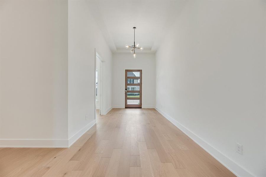 Entryway featuring a chandelier and light wood-type flooring