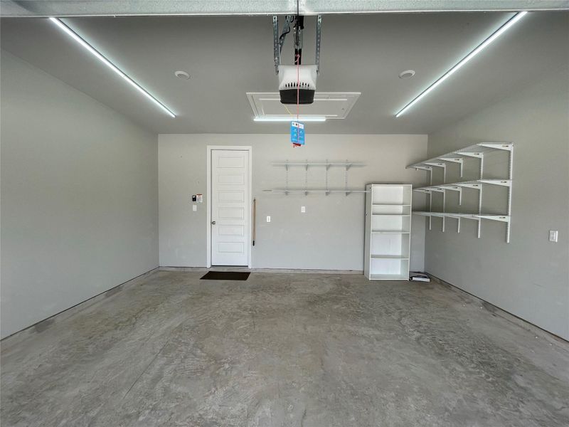 This garage features custom lighting for enhanced illumination, and the installed metal shelving will remain for additional storage. This garage features custom lighting for enhanced illumination, and the installed metal shelving will remain for additional storage.