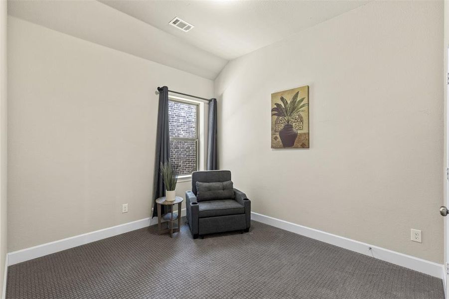 Guest room with lofted ceiling, carpet flooring