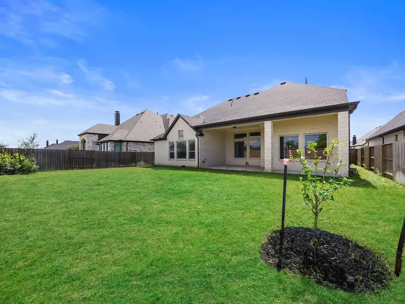 The expansive backyard offers endless possibilities—whether for a future pool, playset, or simply enjoying wide-open green space.