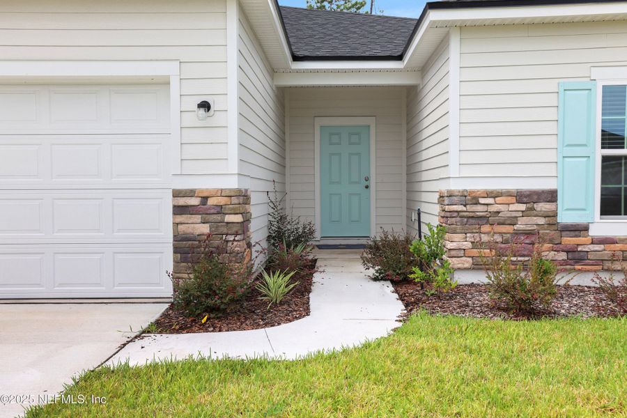 Front exterior of a new home in Cordova Palms, St. Augustine, FL, highlighting curb appeal (Image 17).