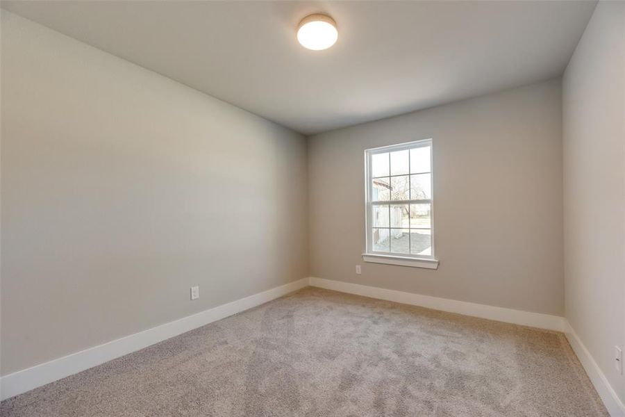 Unfurnished room featuring light carpet