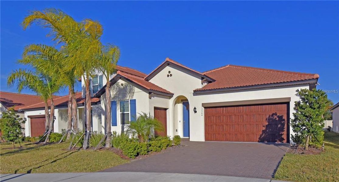 Front exterior of a new home in Southshore Bay Active Adult, Wimauma, FL, highlighting curb appeal (Image 26).