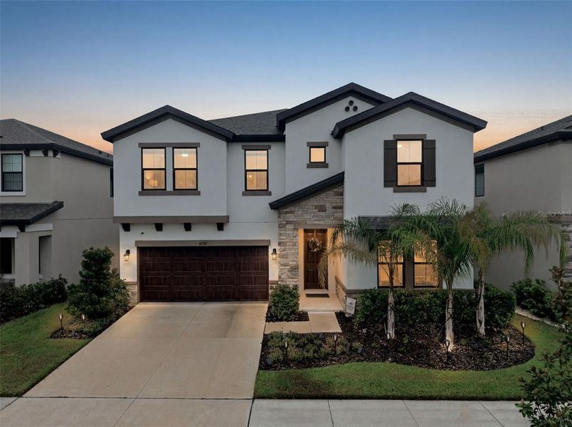 Front exterior of a new home in Hawkstone, Lithia, FL, highlighting curb appeal (Image 26).