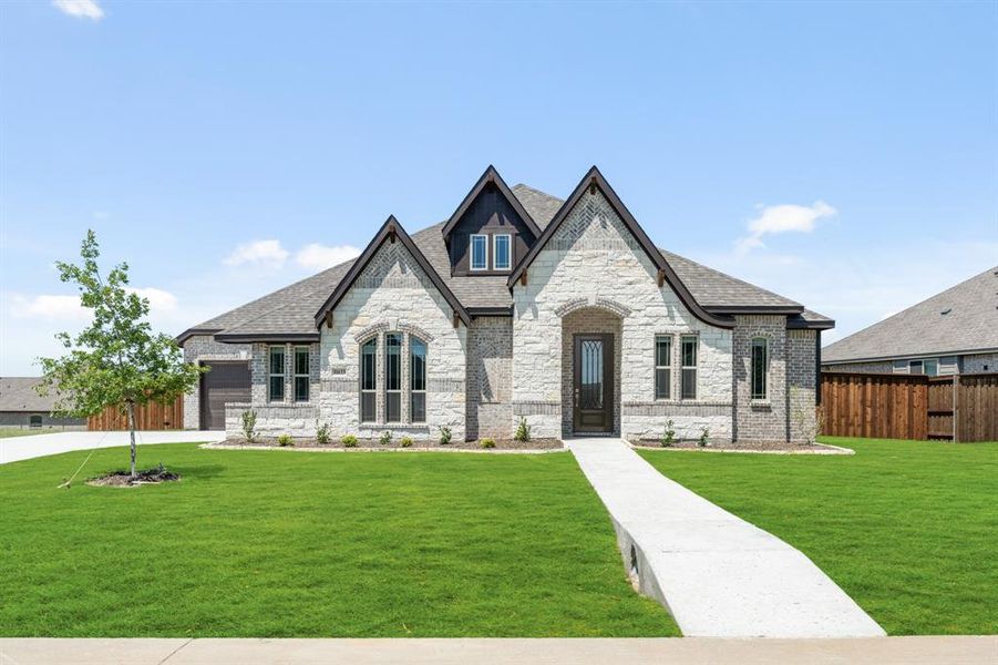 Front exterior of a new home in Wildcat Ridge, Godley, TX, highlighting curb appeal (Image 2). Front exterior of a new home in Wildcat Ridge, Godley, TX, highlighting curb appeal (Image 2).