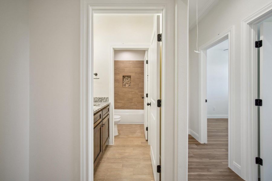 Hall featuring light wood finished floors Hall featuring light wood finished floors