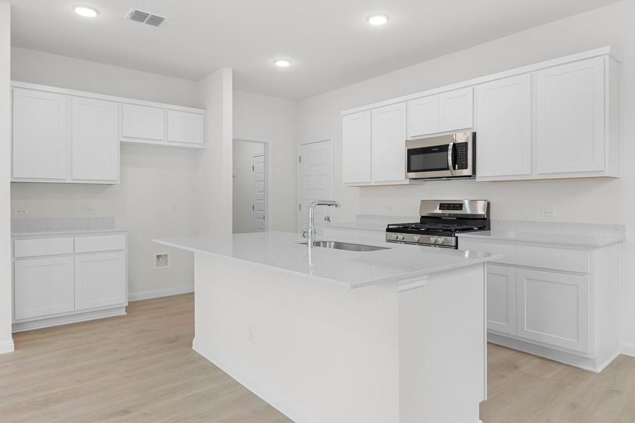 Kitchen in the Magnolia home plan by Trophy Signature Homes – REPRESENTATIVE PHOTO