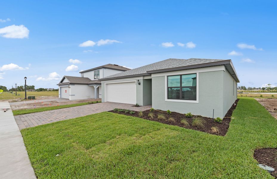 Exterior details and patio area of a home in Whispering Lakes, Lehigh Acres (Image 22).