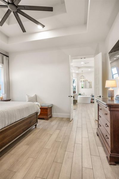 Bedroom featuring ceiling fan and a tray ceiling Bedroom featuring ceiling fan and a tray ceiling