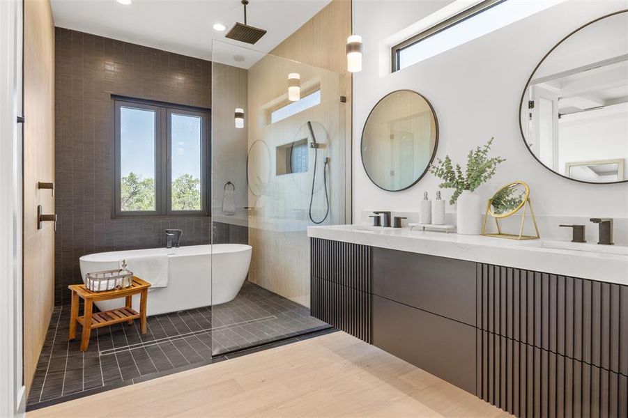 Luxurious bathing quarters with a deep soaking tub and dual vanities.